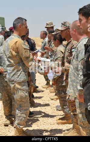 Maj. General Ken Tovo, Combined Joint Task Force Spartan Commander, übergibt Sprungflügel Zertifikate an Fallschirmspringer, die an Übung eifrigen Lion's Freundschaftssprung Mai 10 teilgenommen. Der Schwerpunkt von Eager Lion 2012 liegt auf der Stärkung der militärischen Beziehungen zwischen den Partnerländern. Der Freundschaftssprung ist der erste Schritt, um dieses Ziel zu erreichen, als Fallschirmspringer der kombinierten Joint Task Force Spartan zusammen sprangen. Stockfoto