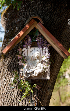 Religiöse Ikonographie Grotte am Baum am Straßenrand auf Pontignano in Chianti-Region der Toskana, Italien Stockfoto