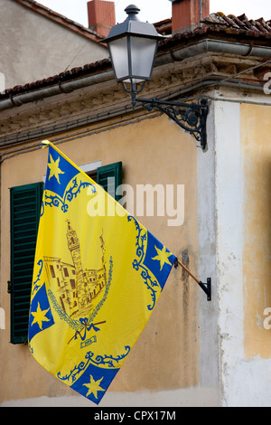 Flagge von Corso Contrada am Fahnenmast in Asciano, in der Toskana, Italien Stockfoto