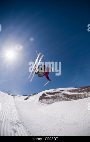 Springen auf verschneiten Hang Skifahrer Stockfoto