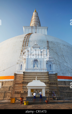 Jungen beten am Ruvanvelisaya Dagoba, Anuradhapura, (UNESCO Weltkulturerbe), North Central Province, Sri Lanka Stockfoto