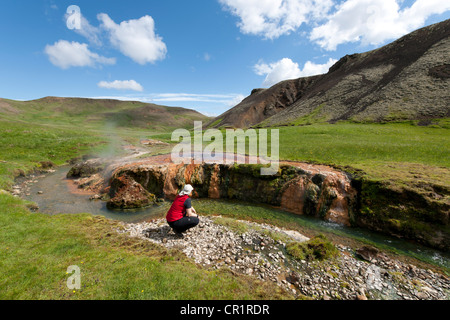 Weibliche Wanderer auf eine heiße Quelle am Fluss Reykjadalsá im Hengill geothermische Bereich bei Hveragerdi, Island, Europa Stockfoto