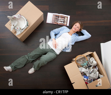 Frau auf Boden mit Boxen Stockfoto