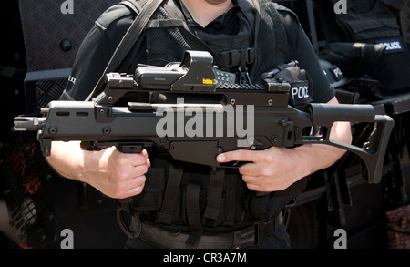 Hampshire, England, Juni 2012. Polizist Schusswaffen bewaffnet mit Heckler und Koch G36C Sturmgewehr mit Eotech mit dem Ziel Gerät. Stockfoto