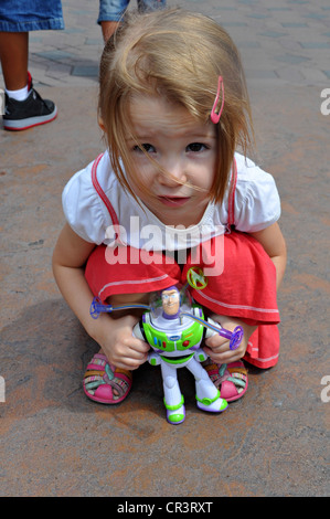 Kleines Mädchen posiert mit Buzz Lightyear aus dem Film "Toy Story" im Disneyland, Anaheim, Kalifornien Stockfoto