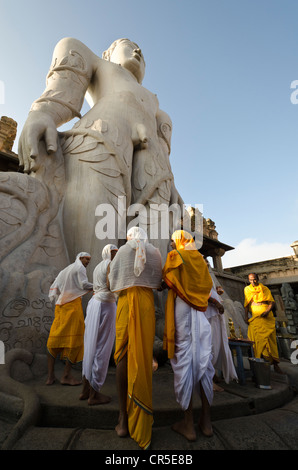 Eine Gruppe von Jain Pilgern tun eine spezielle Pooja die Segnungen von Bahubali von den lokalen Priestern vor der statue Stockfoto