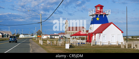 Kanada, New Brunswick, Acadia, Grande Anse, Leuchtturm mit Acadian Farben und St. Simon Church Stockfoto