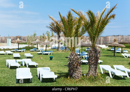 Hotel Gebiet mit weißen Kunststoff Sonnenliegen auf dem grünen Rasen, Tunesien Stockfoto