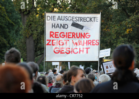 Demonstranten mit ein Banner mit "Regierung weitergeleitet Wahres on', Deutsch für"Regierung ihr wahres Gesicht zeigt"einem Stockfoto