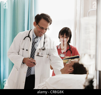 Arzt und Krankenschwester, die Kontrolle über Patienten im Krankenhausbett Stockfoto