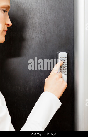 Frau Tür Tastatur drücken Stockfoto