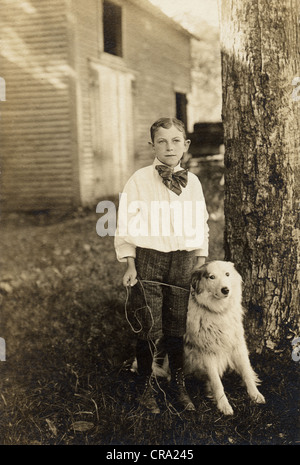 Schicke junge mit großen weißen Hund an der Leine Stockfoto