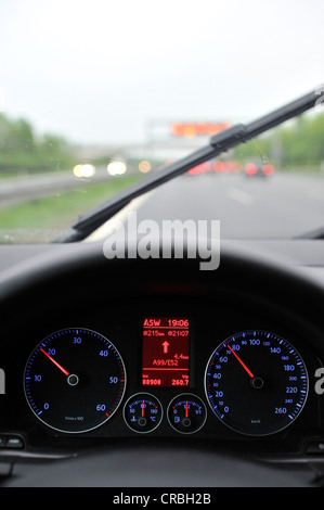 Schlechte Sicht bei Regen, Autobahn, beleuchtete Tachometer mit Navigations-Display, fahren VW Golf Stockfoto