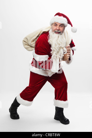 Santa mit Plünderung Weihnachtsgeschenke Stockfoto