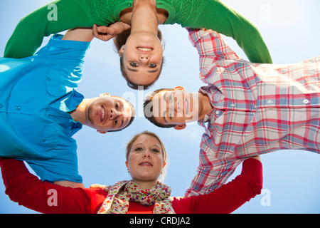 Vier Freunde bilden einen Kreis nach unten Stockfoto