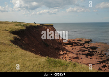 Ein Stuhl sitzt auf den roten Klippen in Hermanville, Prince Edward Island, Kanada. Stockfoto