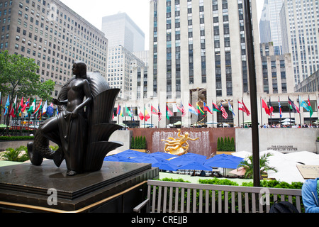 Statue im Outside the Rockefeller Plaza, Center, Manhattan, New York City Schirme des versunkenen Restaurants und Fahnen der nation Stockfoto