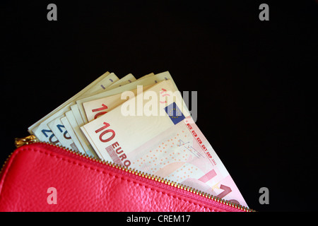 Euro-Banknoten in rosa Handtasche einer Frau Stockfoto