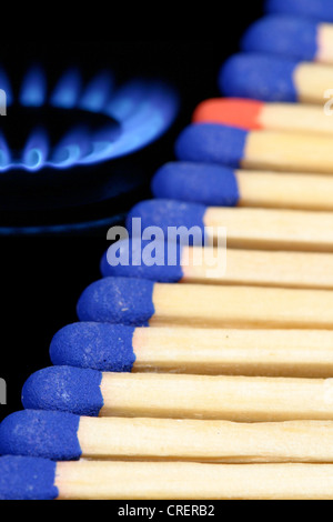 Reihe von blau-Kopf-Spiele mit einem rothaarig Match zwischen ihnen neben einem Gasherd Flamme Stockfoto