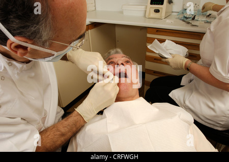 Ein Zahnarzt untersucht den Zustand seiner Patienten Zähne. Stockfoto