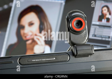 Webcam installiert auf Computer-Monitor, Portrait einer Frau im Hintergrund Stockfoto