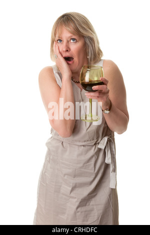 Attractive Mature Woman with Shocked Horrified Expression Holding Large Glass of Red Wine Isolated Stockfoto