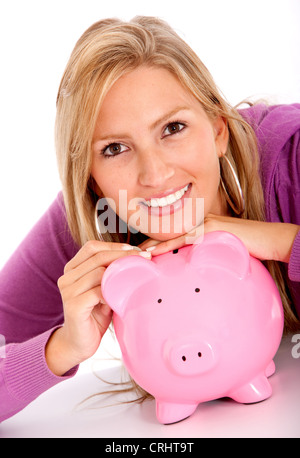 schöne junge blonde Frau mit einem rosa Sparschwein lächelnd contendly Stockfoto