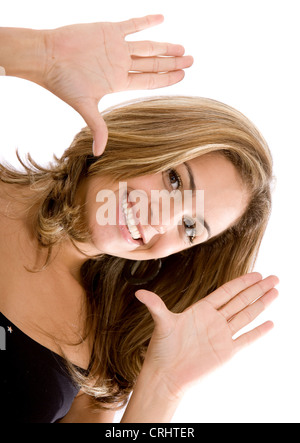 young beautiful brown-haired woman framing her face with her hands Stockfoto