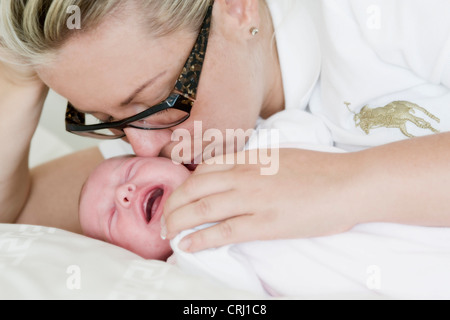 Mutter 2 Wochen alten Baby küssen Stockfoto