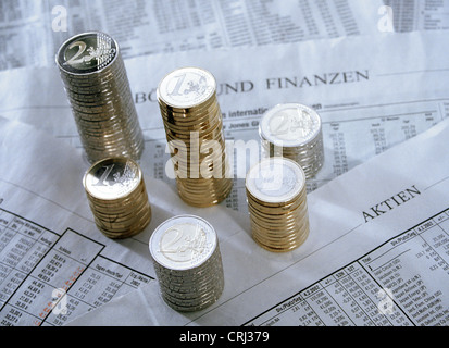 Stapel von Euromuenzen auf einer Zeitungsseite mit Börsenentwicklungen Stockfoto