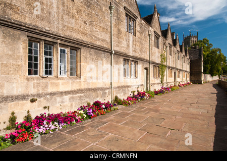 Reihe von Armenhäuser neben einer breiten Platte Weg und St James Kirche in Chipping Campden, Cotswolds, Gloucestershire, England nur sichtbar Stockfoto