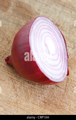 Eine in Scheiben geschnittene rote Zwiebel auf einem hölzernen Hintergrund Stockfoto