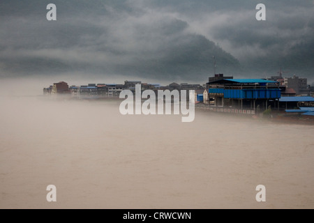 Ein Fluss schwillt und überläuft seinen Banken und Überschwemmungen eine Stadt bei großflächigen Überschwemmungen im Gaungyaun in Nord-Sichuan in China. Stockfoto