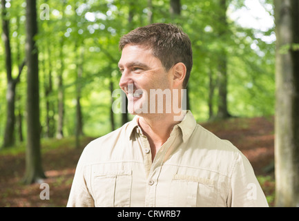 Lächelnder Mann ruht während einer Wanderung in der Natur Stockfoto