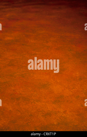 ORANGE LACKIERT CHIAROSCURO-HINTERGRUND Stockfoto