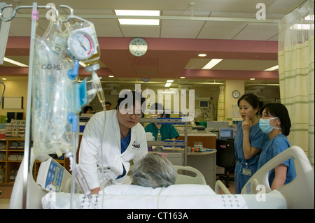 Medizinisches Personal kümmern sich um ein Patient auf der Intensivstation, Samsung Medical Center; Südkorea. Stockfoto