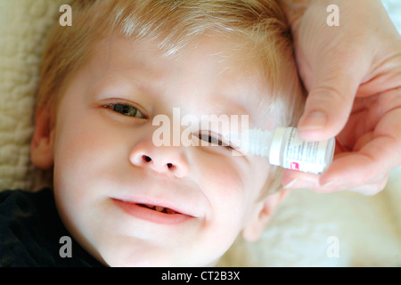 KIND MIT AUGE LOTION Stockfoto