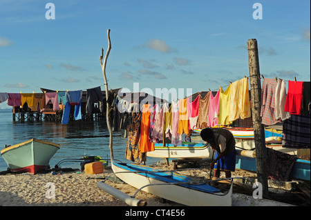 Malaysia, Borneo, Semporna, Mabul, Wäsche trocknen neben lokalen Booten Stockfoto