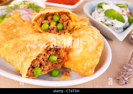 Knackige indischen Samosa Teigtaschen mit einer Füllung aus würzigen gehacktes Lamm Keema und Erbsen. Perfekte Party Essen. Stockfoto