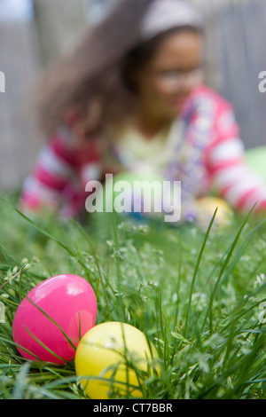 Mädchen auf der Suche nach Ostereiern im Rasen Stockfoto