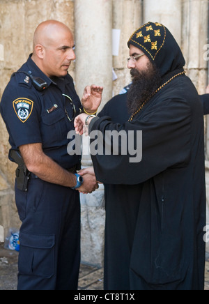 Koptischen Priester mit israelischen Polizisten an der Kirche des Heiligen Grabes in Jerusalem Israel während Karfreitag Stockfoto