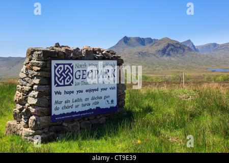 North West Highlands Geopark Gaelic Zweisprachiges Schild mit Ben More Coigach Berg darüber hinaus. Assynt, Ross und Cromarty, Scottish Highlands, Schottland, UK Stockfoto