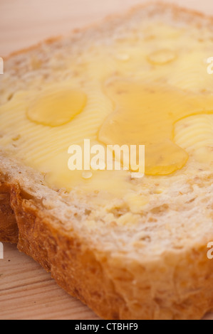 Scheibe Vollkornbrot mit Butter und Honig Stockfoto