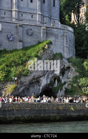 Pilger beten vor der Grotte an der Wallfahrtskirche unserer lieben Frau von Lourdes, Pyrenäen, Frankreich Stockfoto