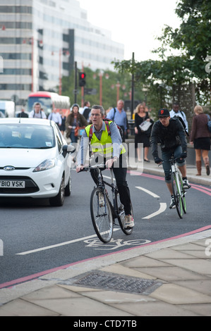 Radfahrer mit einem Radweg auf einer belebten Straße in London, England. Stockfoto