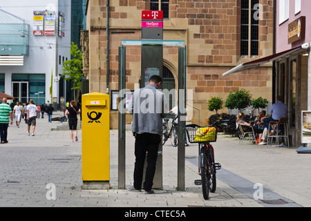 Mann in öffentlichen Telefonzelle Deutsche Post Briefkasten Briefkasten Deutsche Telekom Internet Hotspot Heilbronn Deutschland Europa Stockfoto