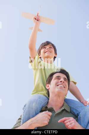 USA, New Jersey, Jersey City, Vater mit Sohn (10-11 Jahre) auf Schultern mit Modellflugzeug Stockfoto