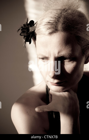 Junge Frau stützte sich auf ihre hand Stockfoto