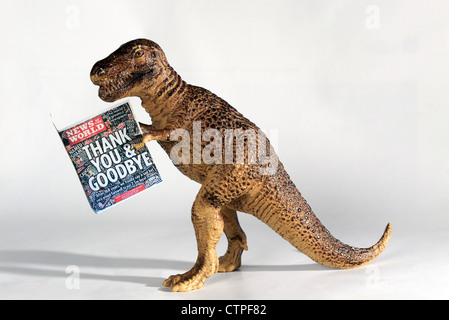 Nachricht von der Welt-Zeitung im Spielzeug Dinosaurier Stockfoto
