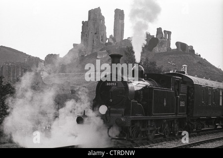 Eine Drummond-Design Klasse M7 südlichen Dampftank Lokomotive 30053 zieht seinen Zug vorbei an den Ruinen von Corfe Castle an der erhaltenen Swanage Railway, The Purbeck Line, Dorset, Süd-West, England. UK Stockfoto